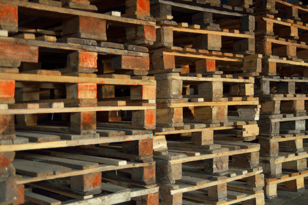 Pile of Recycled Wood Pallets Available For Manufacturers and Distributors Looking For Quality Pallets To Buy
